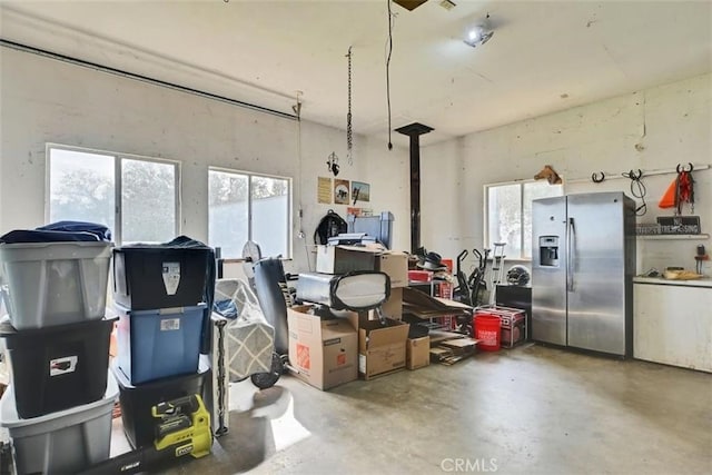 garage with stainless steel fridge with ice dispenser