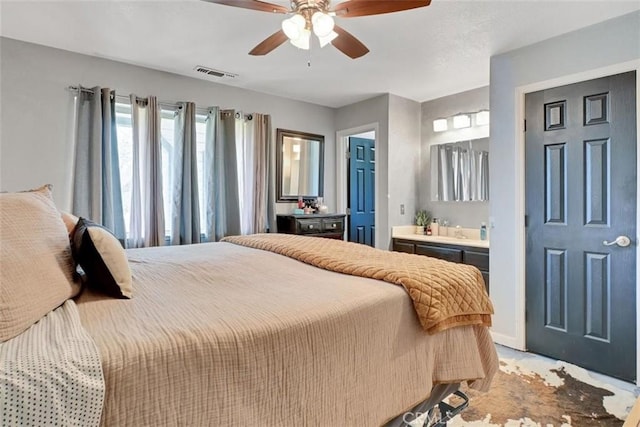 bedroom with ensuite bathroom and ceiling fan