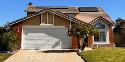 view of front of house featuring a garage and a front lawn