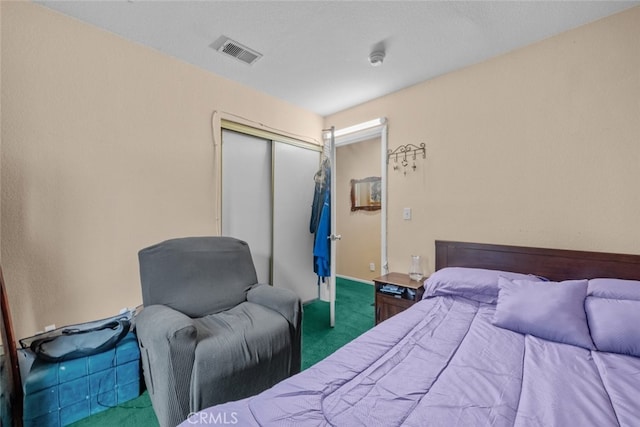 bedroom featuring dark carpet and a closet