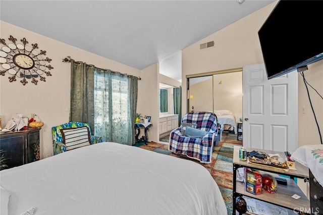 bedroom with lofted ceiling and a closet