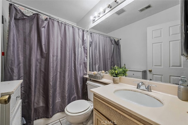 bathroom featuring vanity, toilet, and walk in shower