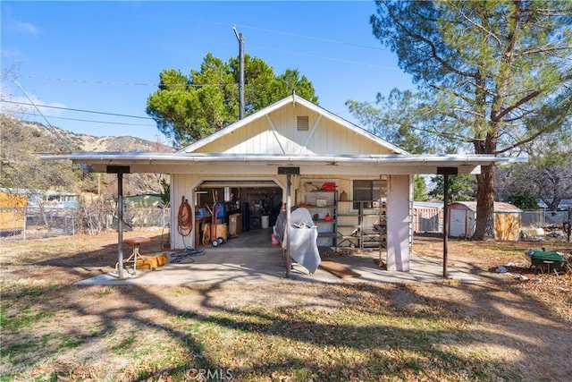 exterior space featuring a garage and a storage unit