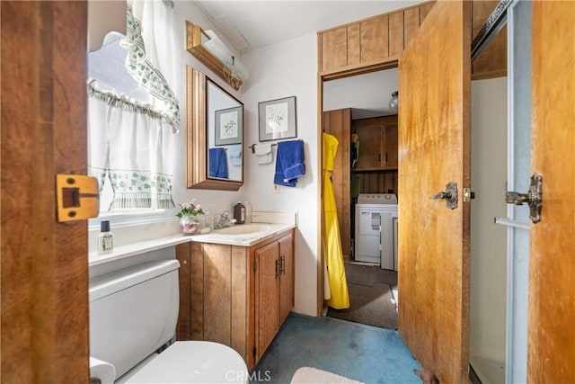 bathroom featuring washer / clothes dryer, vanity, and toilet