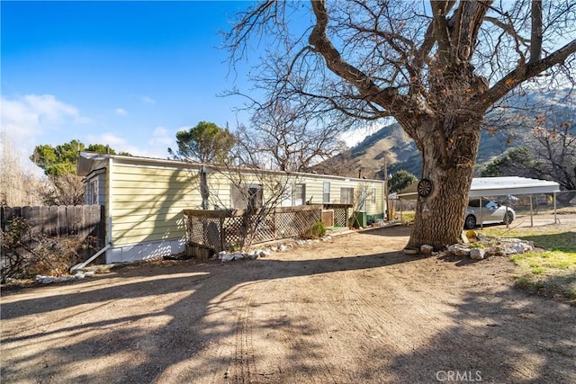 view of front facade with a mountain view and a carport