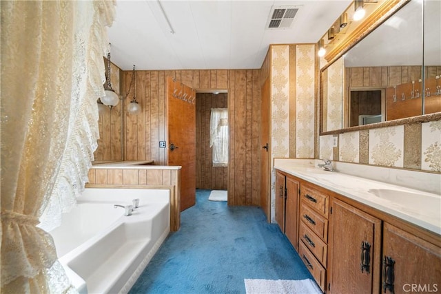 bathroom with vanity and a washtub