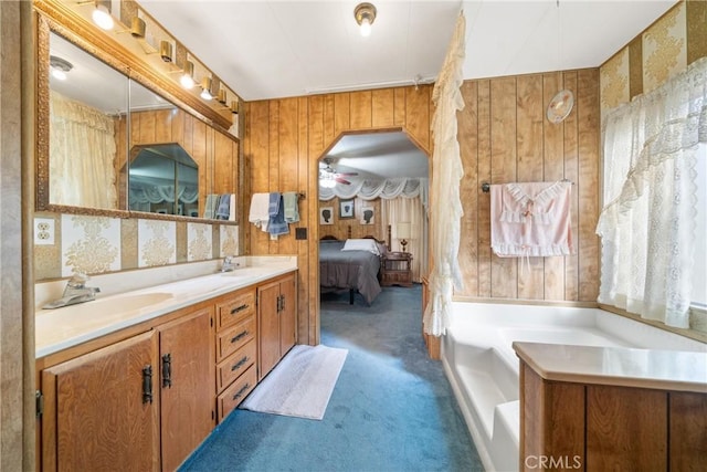 bathroom featuring vanity and a washtub