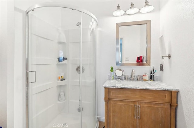 bathroom with an enclosed shower and vanity