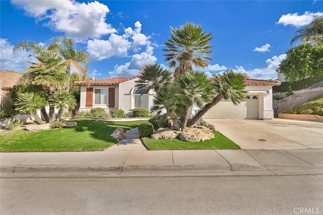 mediterranean / spanish-style house with a garage and a front yard