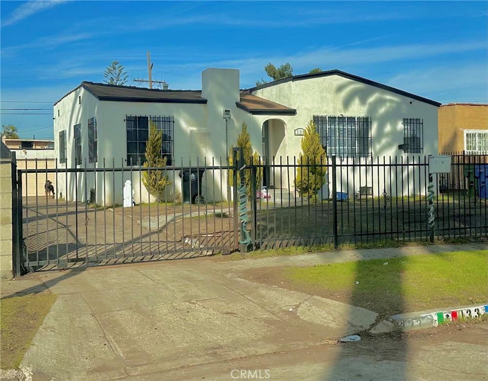 view of front of house with a fenced front yard and stucco siding