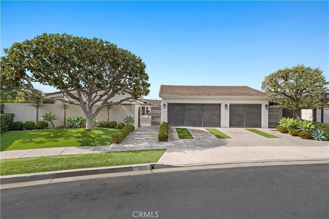 view of front of home with a front yard and a garage