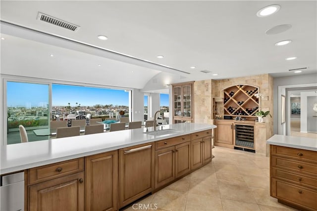 kitchen featuring light tile patterned flooring, sink, and beverage cooler