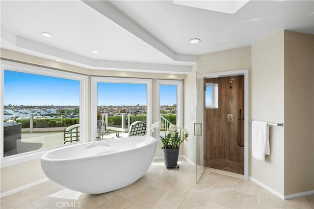 bathroom featuring a skylight and shower with separate bathtub