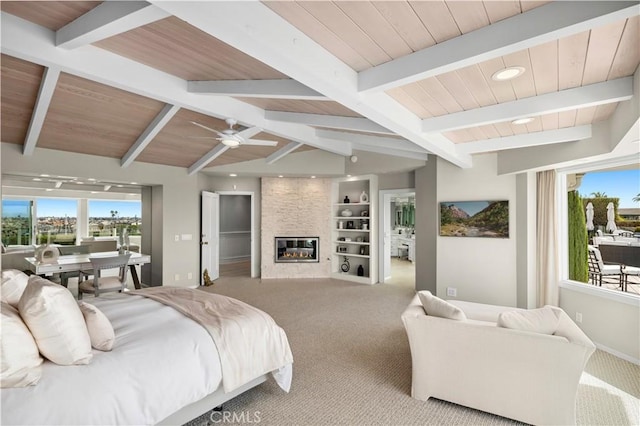 carpeted bedroom featuring a large fireplace, lofted ceiling with beams, and wood ceiling