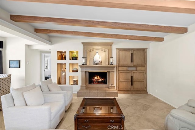 tiled living room with built in features and beamed ceiling