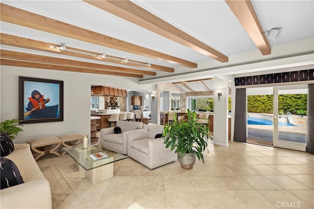 tiled living room featuring beam ceiling