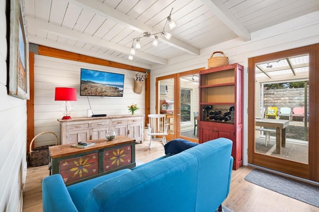 living room featuring rail lighting, wooden ceiling, french doors, beamed ceiling, and light wood-type flooring