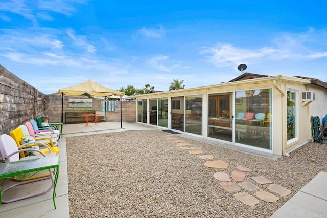 back of property with a sunroom and a patio