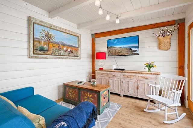 sitting room with beam ceiling, light hardwood / wood-style floors, rail lighting, and wooden ceiling