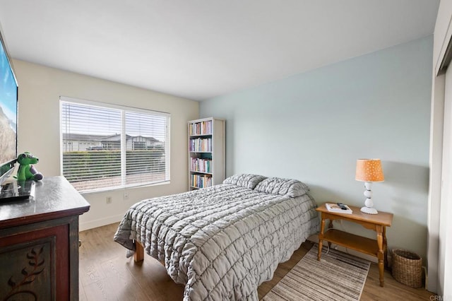 bedroom with hardwood / wood-style floors