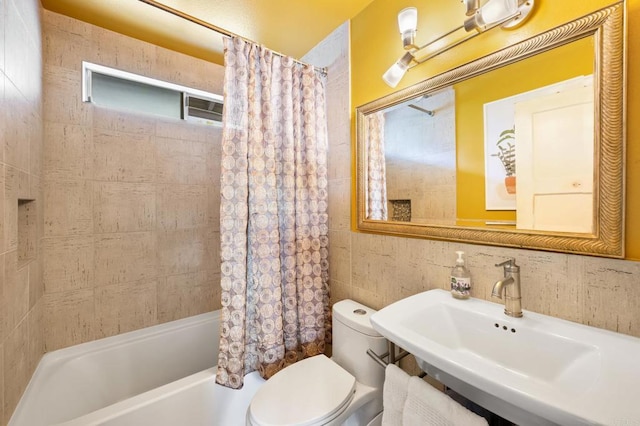 full bathroom featuring sink, shower / bath combination with curtain, and toilet