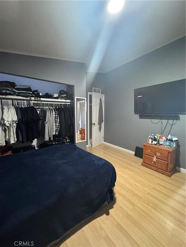 8734 Nevada Rd, Phelan, CA 92371 - bedroom with a closet, vaulted ceiling, visible vents, wood finished floors, and baseboards