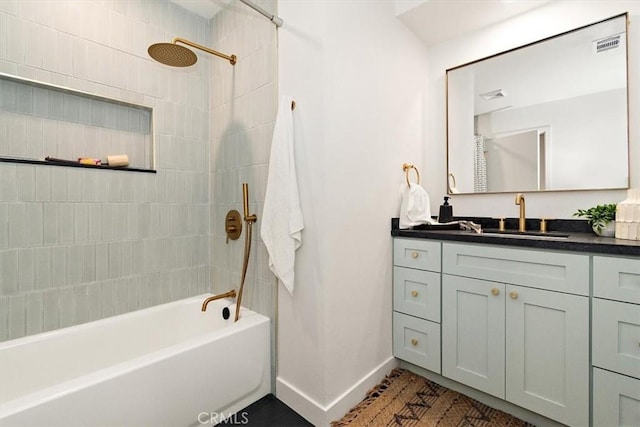 bathroom featuring vanity and tiled shower / bath combo