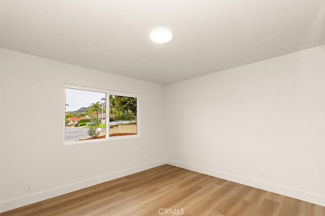 spare room featuring wood-type flooring