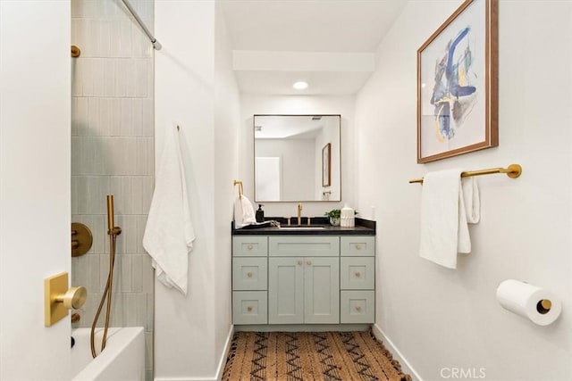 bathroom featuring vanity and tiled shower / bath