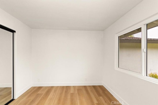 unfurnished room with light wood-type flooring