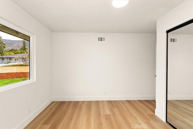 unfurnished bedroom featuring light wood-type flooring