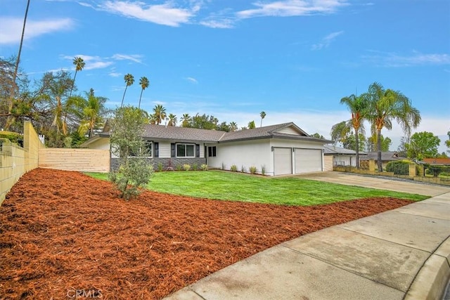 ranch-style home with a garage and a front yard