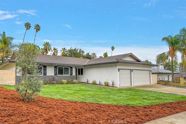 ranch-style house featuring a garage and a front yard