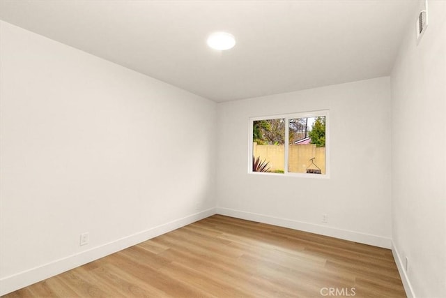 spare room featuring light hardwood / wood-style floors