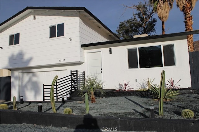 back of property featuring an attached garage