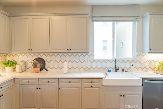 kitchen with dishwasher, sink, and white cabinets