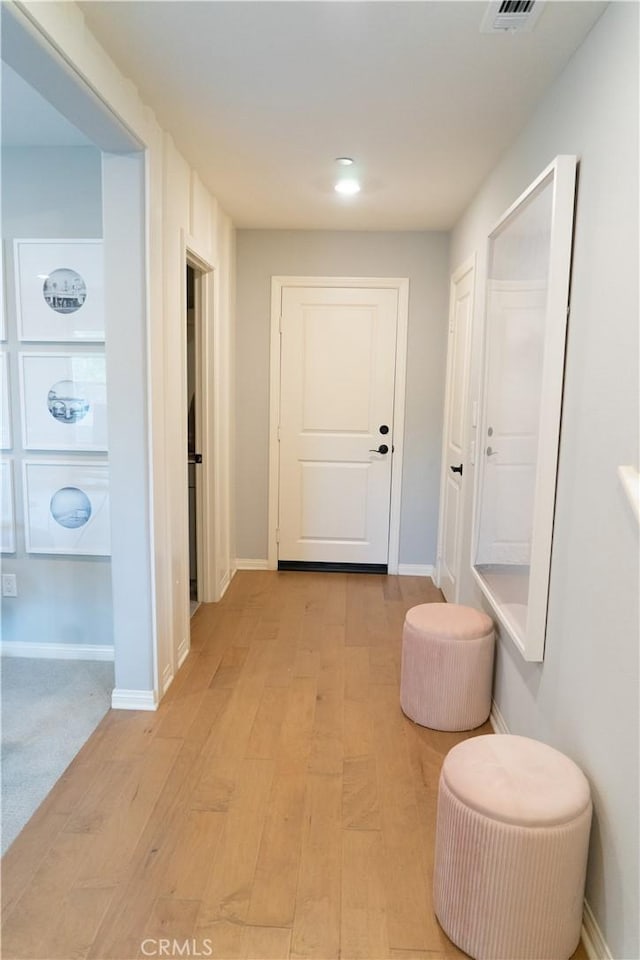 hallway with light hardwood / wood-style flooring