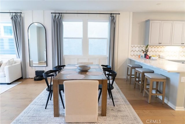 dining space featuring light wood-type flooring