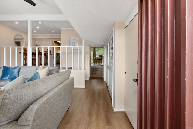 hall featuring recessed lighting, baseboards, wood finished floors, and ornamental molding