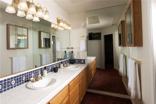 bathroom with double vanity, a sink, and baseboards