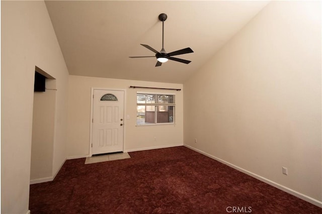 unfurnished room featuring lofted ceiling, baseboards, ceiling fan, and carpet