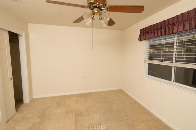 spare room with light carpet and baseboards