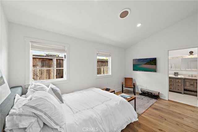 bedroom featuring vaulted ceiling and light hardwood / wood-style floors