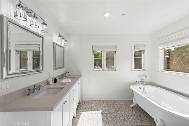 bathroom featuring tile patterned flooring, vanity, and a bathtub