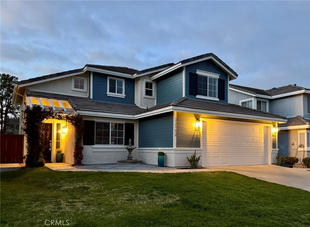 view of front of house with a garage and a front yard