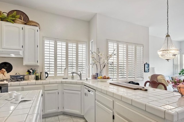 kitchen featuring pendant lighting, tile countertops, white cabinets, stainless steel gas cooktop, and white dishwasher