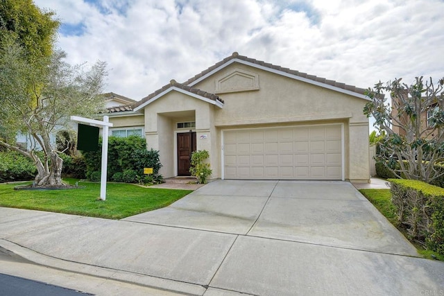 ranch-style house featuring a garage and a front lawn