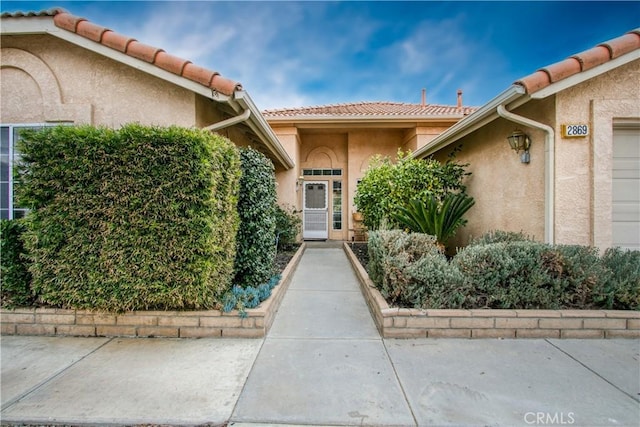 2869 Maple Dr, Hemet, CA 92545 - doorway to property featuring a tiled roof and stucco siding