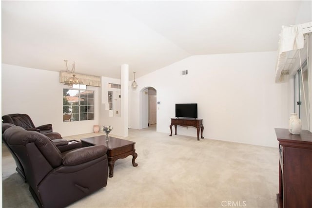 2869 Maple Dr, Hemet, CA 92545 - living room featuring arched walkways, light colored carpet, and lofted ceiling