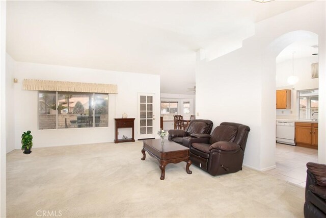 2869 Maple Dr, Hemet, CA 92545 - living room featuring light carpet, arched walkways, and healthy amount of natural light